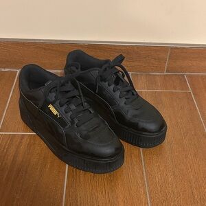Black Puma platform sneakers.